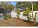 Landscaped backyard with white fence at 7101 69Th N St, Pinellas Park, FL 33781