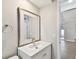 Small bathroom with white vanity and a framed mirror at 7101 69Th N St, Pinellas Park, FL 33781