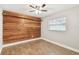 Bedroom with wood-look floors and an accent wood wall at 7101 69Th N St, Pinellas Park, FL 33781