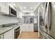 Modern kitchen with stainless steel appliances and white cabinets at 7101 69Th N St, Pinellas Park, FL 33781