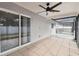 Relaxing screened patio with tile floor, ceiling fan, and access to backyard at 7101 69Th N St, Pinellas Park, FL 33781
