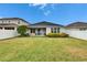 Spacious backyard with grassy area and fence at 7102 Wesley Palm Way, Wesley Chapel, FL 33545