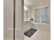Modern bathroom with double vanity, soaking tub, and walk-in shower at 7102 Wesley Palm Way, Wesley Chapel, FL 33545