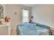 Cozy bedroom with a bed, dresser, and charming decor at 7102 Wesley Palm Way, Wesley Chapel, FL 33545