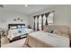 Spacious bedroom with two beds, ample natural light, and neutral decor at 7102 Wesley Palm Way, Wesley Chapel, FL 33545