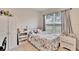 Spacious bedroom with floral bedding, window, and built in shelving at 7102 Wesley Palm Way, Wesley Chapel, FL 33545