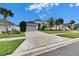 Single-Gathering home with gray siding and a two-car garage at 7102 Wesley Palm Way, Wesley Chapel, FL 33545
