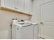 Laundry room with washer, dryer, and cabinets at 7102 Wesley Palm Way, Wesley Chapel, FL 33545