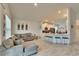 Living room features a sectional sofa and open kitchen view at 7102 Wesley Palm Way, Wesley Chapel, FL 33545