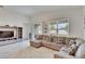 Spacious living room with sectional sofa and backyard access at 7102 Wesley Palm Way, Wesley Chapel, FL 33545