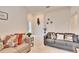 Open living area with gray sofas, and view into entryway at 7102 Wesley Palm Way, Wesley Chapel, FL 33545