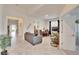 Bright living room with gray sofas and tile floors at 7102 Wesley Palm Way, Wesley Chapel, FL 33545