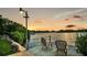 Serene waterfront dock with seating, ideal for enjoying sunsets at 7127 Peninsular Dr, New Port Richey, FL 34652