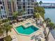 Resort-style pool and spa with plenty of lounge chairs at 7300 Sun Island S Dr # 203, South Pasadena, FL 33707