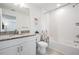 Clean bathroom with granite countertop, white cabinets, and a shower/tub combo at 7678 Notched Pine Bnd, Wesley Chapel, FL 33545