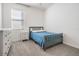 Cozy bedroom with a gray bed frame and white dresser at 7678 Notched Pine Bnd, Wesley Chapel, FL 33545