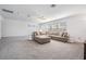 Large bonus room with sectional sofa and ample space at 7678 Notched Pine Bnd, Wesley Chapel, FL 33545