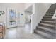 Modern entryway with gray carpeting and open floor plan at 7678 Notched Pine Bnd, Wesley Chapel, FL 33545