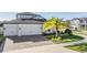 Two-story house with a two-car garage and nicely landscaped yard at 7678 Notched Pine Bnd, Wesley Chapel, FL 33545