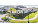 Two-story house with a front porch and nicely landscaped yard at 7678 Notched Pine Bnd, Wesley Chapel, FL 33545