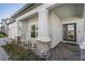 Front porch with rocking chairs, welcoming entryway at 7678 Notched Pine Bnd, Wesley Chapel, FL 33545