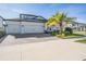 Two-story house with three-car garage and palm tree at 7678 Notched Pine Bnd, Wesley Chapel, FL 33545
