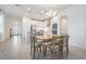 Bright kitchen features white cabinets, stainless steel appliances, and an island with seating at 7678 Notched Pine Bnd, Wesley Chapel, FL 33545