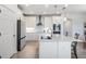 Modern kitchen with white cabinets and quartz countertops at 7678 Notched Pine Bnd, Wesley Chapel, FL 33545