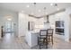 Spacious kitchen with white cabinets and large island at 7678 Notched Pine Bnd, Wesley Chapel, FL 33545
