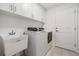 Laundry room with washer, dryer, and utility sink at 7678 Notched Pine Bnd, Wesley Chapel, FL 33545