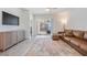 Relaxing living room with leather furniture and view of the pool at 7678 Notched Pine Bnd, Wesley Chapel, FL 33545