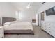Main bedroom features a king-size bed and access to a sitting room at 7678 Notched Pine Bnd, Wesley Chapel, FL 33545