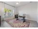 Bright home office with hardwood floors and large window at 7678 Notched Pine Bnd, Wesley Chapel, FL 33545