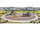 Community playground with play structures, benches, and shaded areas at 7678 Notched Pine Bnd, Wesley Chapel, FL 33545