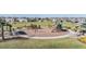 Modern playground with play structures and shaded seating areas at 7678 Notched Pine Bnd, Wesley Chapel, FL 33545