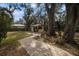 Brick pathway leads to a backyard shed nestled amongst mature trees at 8575 Carey Rd, Lithia, FL 33547