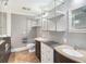 Modern bathroom with double sinks, custom shelving and tile floor at 8575 Carey Rd, Lithia, FL 33547