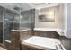 Bathroom with soaking tub, glass shower, and stylish tile at 8575 Carey Rd, Lithia, FL 33547