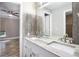 Bathroom with double vanity and wood-look tile at 8575 Carey Rd, Lithia, FL 33547