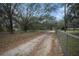 Long driveway leading to the property with chain link fence at 8575 Carey Rd, Lithia, FL 33547