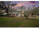 Two-story house with a landscaped yard at dusk at 8575 Carey Rd, Lithia, FL 33547
