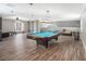 Game room with pool table, sectional sofa, and built-in shelving at 8575 Carey Rd, Lithia, FL 33547