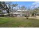 Two-story house with a metal roof and landscaping at 8575 Carey Rd, Lithia, FL 33547