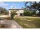 Back exterior of the house showing a patio and landscaping at 8575 Carey Rd, Lithia, FL 33547