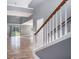 View of a staircase with white railing and gray walls, leading to an open living area at 8575 Carey Rd, Lithia, FL 33547