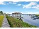 Private wooden dock with covered boat lift and waterfront access at 8839 W Millpoint Rd, Riverview, FL 33578