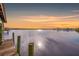 Wooden dock extending over calm waters at sunset at 8839 W Millpoint Rd, Riverview, FL 33578