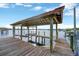 Covered waterfront dock with boat lift and stunning views at 8839 W Millpoint Rd, Riverview, FL 33578