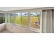Sunroom with large windows offering scenic waterfront views at 8839 W Millpoint Rd, Riverview, FL 33578
