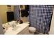 Bathroom with black and white checkered curtain at 8999 Founders Cir, Palmetto, FL 34221